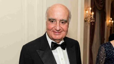 Billionaire banker Safra Edmond attending an exclusive celebrity gala in a black tuxedo.