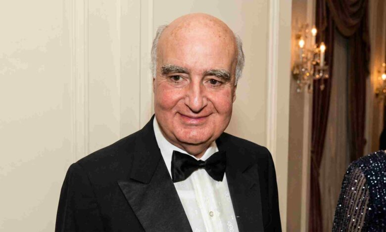 Billionaire banker Safra Edmond attending an exclusive celebrity gala in a black tuxedo.